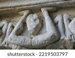 Small photo of Antique column capital with figure in obscene body position