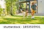 Small photo of Handsome Young Boy Plays Soccer with Happy Golden Retriever Dog at the Backyard Lawn. He Plays Football and Has Lots of Fun with His Loyal Doggy Friend. Idyllic Summer House.