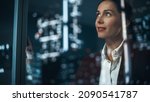 Small photo of Office: Successful Businesswoman in Stylish Suit Working, Looking in Wonder at Night City. Stylish Female CEO Working Late and Hard to Create e-Commerce Online Shopping Experience Sustainable and Safe
