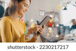 Small photo of Social Media Visualization Concept: Happy Young Woman Uses Digital Tablet Computer in the Office, Social Media Posts, Smiley Faces, e-Commerce Online Shopping Digital Icons Flying Around the Device