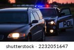 Small photo of Highway Traffic Patrol Car Pulls over Vehicle on the Road. Male Police Officer Approaches and Asks Driver for License and Registration. Officer of the Law doing Job Professionally. Cinematic Wide Shot