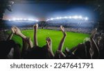Small photo of Establishing Shot of Fans Cheer for Their Favorite Team on a Stadium During Soccer Championship Match. Teams Play, Crowds of Fans Scream, Celebrate Victory, Goal. Football Cup Tournament