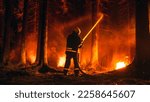 Small photo of Professional Firefighter Quickly Extinguishing a Forest Fire with the Help of a Fire Hose. Fireman Rescuing Wildland from Uncontrollable Brushfire With Water Hose. Shot from the Back