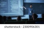 Small photo of Portrait of a Young Male Teacher Giving a Data Science Lecture to Diverse Multiethnic Group of Female and Male Students in Dark College Room. Projecting Slideshow with a Neural Network Model