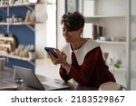 Small photo of Happy successful woman small business owner chatting on mobile phone while working in pottery shop, joyful female ceramic artist newbie entrepreneur holding smartphone making first sale online