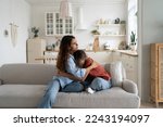 Small photo of Loving caring mother hugging teen daughter. Parent mom showing understanding and support to upset sad teenage girl. Crying child sharing feelings with mommy while sitting together at home