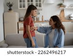 Small photo of Pre-teen girl daughter feeling pain located in lower right side of belly, sick child telling worried mother parent about discomfort in stomach, having symptoms of appendicitis. Kids and stomachache