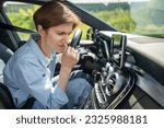 Small photo of Woman driver feeling unpleasant smell from air conditioner in hot weather driving car. Time for maintenance, repair transport. Sad confused angry middle aged female dissatisfied with car breakdown.