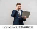 Small photo of Frustrated businessman with laptop in hands. Worried trader man failed on stock exchange failed in trading, falling sales, business collapse, difficulties financial problems, burnt investments