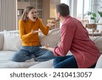 Small photo of Angry excited emotional hysterical woman blaming, shouting at justifying defensive man bringing arguments, explanations. Toxic relations, gaslighting, conflict, scandal, marital discord in family life