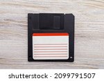 Small photo of Floppy disk on the table. Nostalgia concept. A rudiment or object that has gone down in history. Background with copy space for text