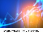 Small photo of Classic incandescent light bulb on blurred background of abstract toned stock chart, selective focus. The concept of the energy crisis and electricity inflation. Rising electricity prices