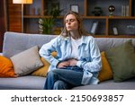Small photo of Woman hand in stomach ache, suffer from food poisoning, abdominal pain and colon problem, gastritis. Patient belly, abdomen or inflammation, concept.