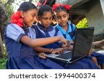 indian village government school girls operating laptop computer system at rural area in india