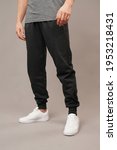 Small photo of men track suit ​in front of grey background in studio