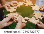 Small photo of jigsaw puzzle pieces communication teamwork unite power teamwork and unity in hand teamwork concept