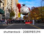 Small photo of Balloons of different characters seen floating over Sixth Avenue during the 95th annual Macy's Thanksgiving Day Parade in New York City on November 25, 2021.