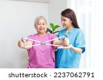 Small photo of professional physical therapist Helping physical therapy for elderly female patients Exercise your wrists and strengthen your muscles. physical therapy center for rehabilitation of elderly patients