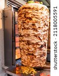 Grilled chicken meat on a vertical rotisserie used in traditional turkish street food Doner Kebab (Shawarma or Gyros in other cultures) in Istanbul, Turkey