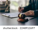 Small photo of Lawyer office male working with hammer and scales with document, contract, legal adviser concept.
