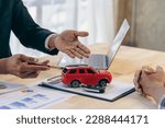 Small photo of Salesman guiding customer seated at table. Car business. Car sale. Dealership closing. and the new owner has entered into a contract The idea of ​​selling and renting a car with insurance.