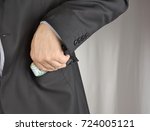Small photo of Pencil pusher asking for a bribe in euros or in dollars. Putting money in the pocket.