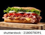 Small photo of Submarine sandwich with ham, cheese, lettuce, tomatoes,onion, mortadella and sausage on wooden table