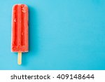 Strawberry popsicle. Blue background
