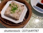 Small photo of Yumcha, dim sum,Hong Kong in bamboo basket asian dim sum menu Steamed Cantonese Style Turnip Cake ,Raw Turnip cake (Chinese : Chai tow kway ). Chinese traditional local dish radish cake in restaurant