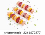 Small photo of Raw chicken meat skewers with vegetables,plums,yellow pepper,onions,with spices,herbs white background.Top view.Chicken Skewers breast fillet meat.Uncooked meat skewer.Skewers with pieces of raw meat.