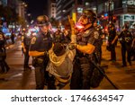 Small photo of A protester is being taken by policemen. Many protesters gathered around in front of White House in Washington DC on 5/30/2020.