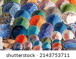 Small photo of Handicraft, bright ceramic ware with a traditional ornament in the street market.