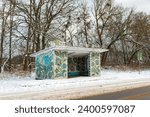 Small photo of Sinovaly, Ukraine - January 16, 2021: A historical artifact of a bygone era of the USSR, a traditional old Soviet bus stop with an old authentic mosaic in ethnic style preserved on the wall.