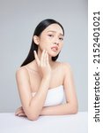Small photo of Young Asian woman touch and worry about her face. Acne, pimple, clear and clean, oily, dry skin concept.