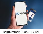 Small photo of META logo on smartphone being held in hand in front of phone with Facebook icon. Facebook changes company name to Meta and focuses on Metaverse in its rebrand. Swansea, UK - October 30, 2021.