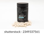 Small photo of Fuji, Shizuoka, Japan - May 27, 2023: MAG LT Magtein Supplement: MAG LT Magtein 2000 mg by Sports Research with Veggie Capsules Scattered. Isolated on White Background.