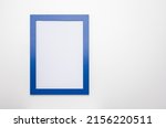 Small photo of upright photo frame mockup on white wall. blank diploma frame on white wall background
