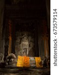 Small photo of A stone statue of the Buddha reclining on His deathbed in an ancient shrine room in Angkor Wat - Siem Reap, Cambodia
