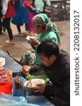 Small photo of MEO VAC, VIETNAM- November 1, 2015: woman and man from Vietnamese ethnic groups wearing traditional clothing, having lunch in the covered market of the township of Meo Vac, Northeast Vietnam.