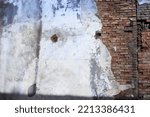 Small photo of Texture of a brick wall with old plaster. Rustic style. Mangy background