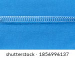 Internal machine seam on blue knitted material. Types of seams when sewing and cutting clothes