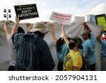 Small photo of Austin, TX, USA - Oct. 2, 2021: Activists face off at the Women's March rally at the Capitol to protest SB 8, Texas' abortion law that effectively bans abortions after six weeks of pregnancy.