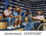 Small photo of Diverse group of students in college library including young woman in wheelchair enjoying discussion