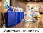 Small photo of Goodie bags on a wooden table with cupcakes