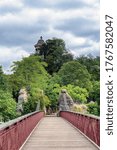 Small photo of Paris, France - June 30 2020: Footbridge in the Parc Buttes-Chaumont with Sybil Temple in the background - Paris, France