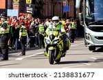 Small photo of Cardiff, Wales - March 2022: Police motorcycle outrider escorting a team bus in Cardiff city centre