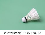 Shuttlecock badminton on green background with copy space
