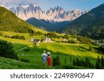 Small photo of couple viewing the landscape of Santa Maddalena Village in Dolomites Italy, Santa Magdalena village magical Dolomites mountains, Val di Funes valley, Trentino Alto Adige region, South Tyrol, Italy