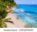 Anse Patates Beach La Digue Island Seychelles, Drone aerial view of La Digue Seychelles bird eye view of a tropical Island, couple men and woman walking at the beach during sunset at a luxury vacation
