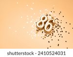 Small photo of 86 years celebration festive background made with golden candles in the form of number Eighty-six lying on sparkles. Universal holiday banner with copy space.